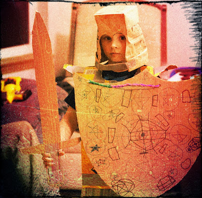 Kid in homemade cardboard knight costume