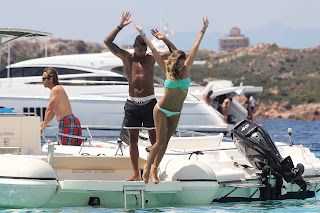 Melissa Satta jumping in the water from the boat