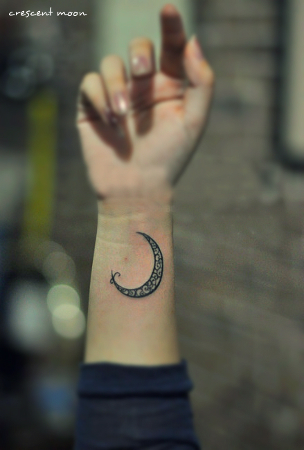 crescent moon tattoo on the arm