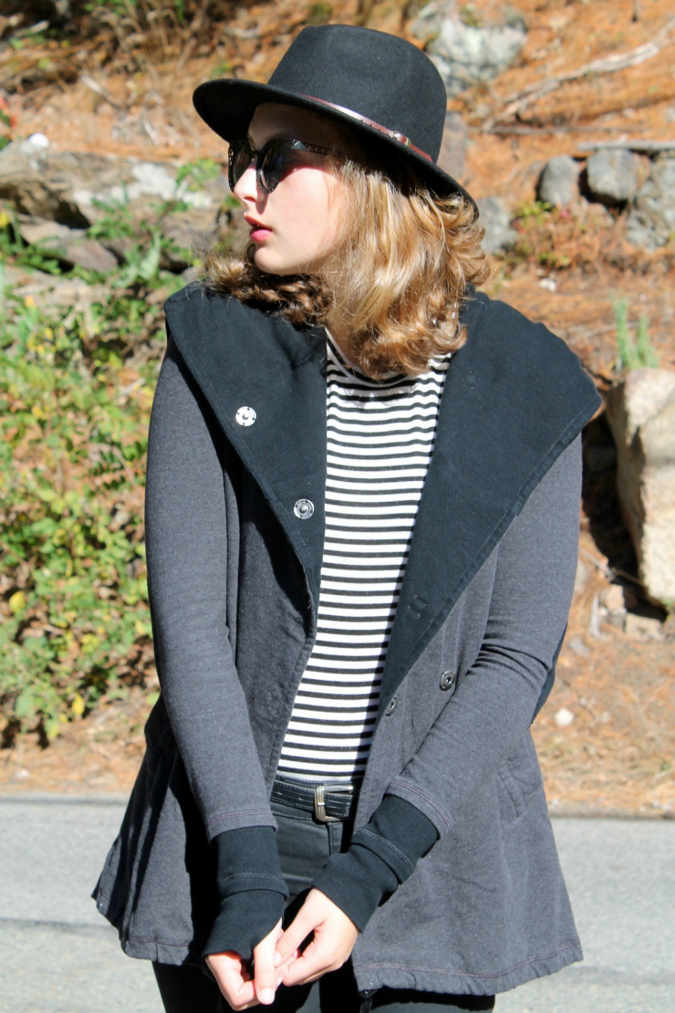 Black outfit with a Lululemon vest and fedora