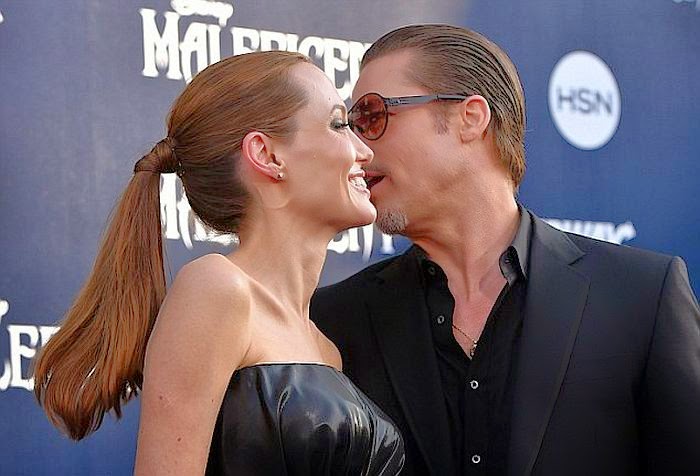 Angelina Jolie and Brad Pitt are still engaged as they on a red carpet in Los Angeles Angelina Jolie was trying to apply her perfect fashion statement when she wore a beautiful black dress alongside her boyfriend Brad Pitt on Wednesday, May 28, 2014 at Los Angeles, USA.