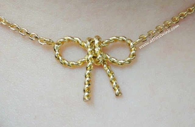 TOV Essentials gold ribbon necklace close-up