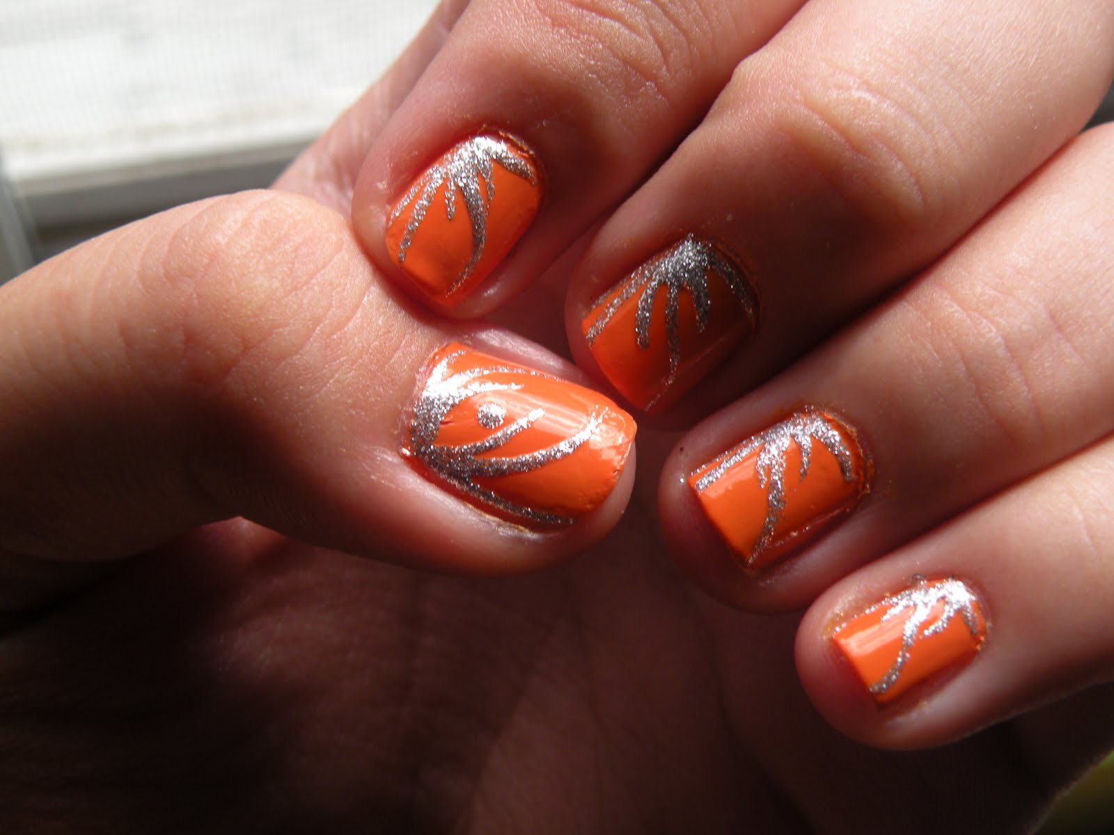 orange and silver nail design