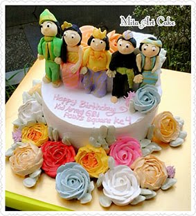 Flowers cake with traditional people on top