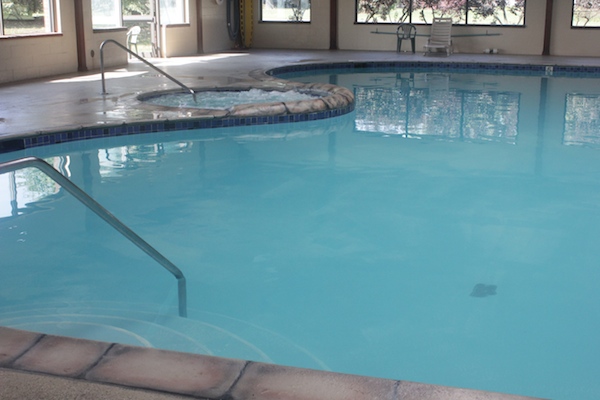 Indoor swimming pools are more likely to trap noxious gases and chloramines in the surrounding environment which can lead to negative health consequences such as eye irritations, dermatitis, asthma, and even miscarriages, birth defects, and cancer.  
