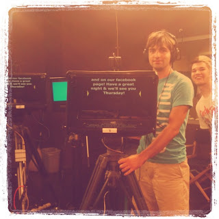 Standing next to a studio camera