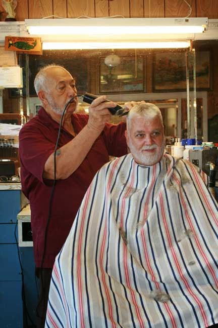 ... , gives John Hamm a trim Friday, Sept. 5, at the Stover Barber Shop
