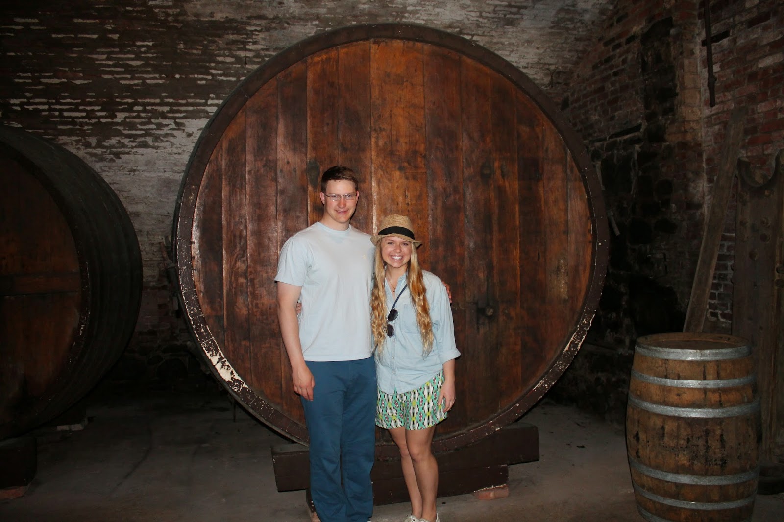 Winey children in front of a Brotherhood Winery cellar barrel