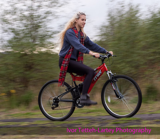 Young Woman on a Bike Creative photography caputing movement.