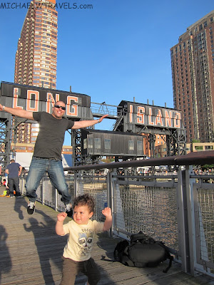 a man and child jumping on a dock