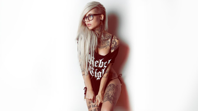 Nerdy tattooed girl with glasses