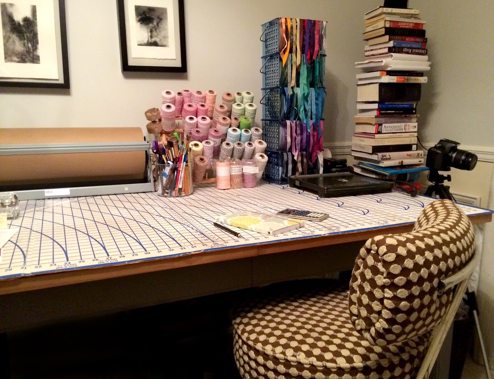 work table in studio with ribbons, twine and books.