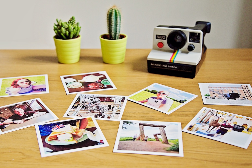 Polaroid land camera with Sticky9 print box with Instagram prints and cacti decoration. Polaroid land camera with Sticky9 print box with Instagram prints and cacti decoration.