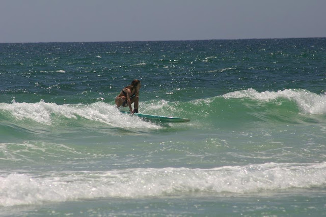 Cinco De Mayo 2012 Woman longboard surfing on Pensacola Beach, FL at 18th Ave.