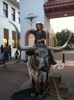 a woman riding a bull