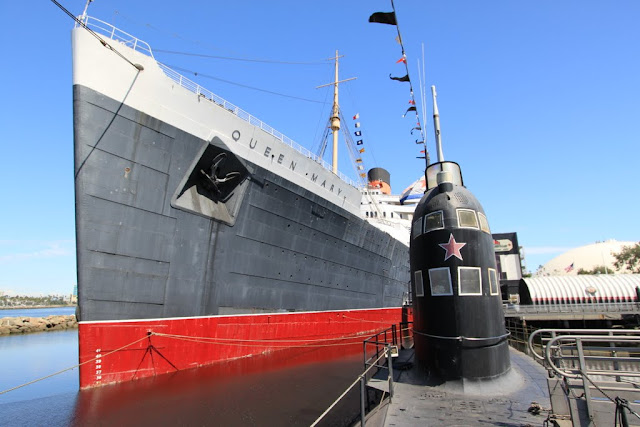The front view of the Russian Scorpion Submarine and Queen Mary's cruise ship as I am staying on top of the submarine at Long Beach, Los Angeles, California, USA The front view of the Russian Scorpion Submarine and Queen Mary's cruise ship as I am staying on top of the submarine at Long Beach, Los Angeles, California, USA