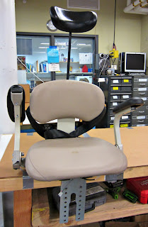 The modified stairlift chair  with an extended headrest.
