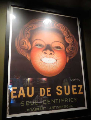Art deco Eau de Suez dentifrice poster with huge female head and sparkling white teeth