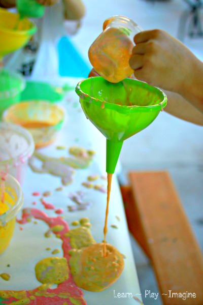 Beautiful and messy art for kids - pour painting with funnels!