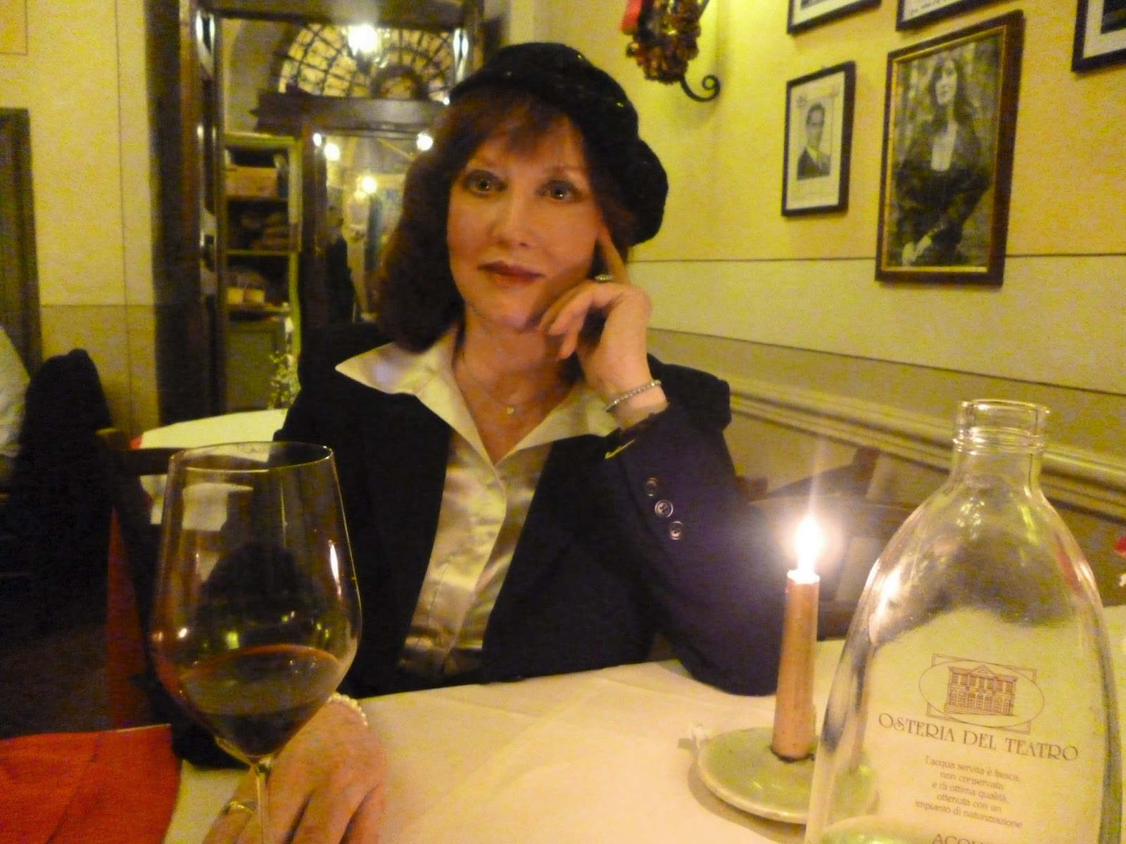 a picture of author Laura Graham drinking wine in a nice restaurant