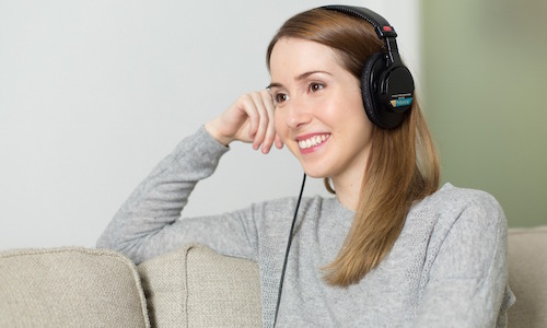 woman listening to music to reduce stress
