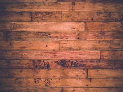 horizontal image of a wooden floor with shoe prints