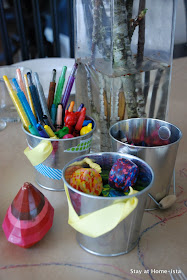 bundles of crayons on a craft paper table for dinnertime crafting to keep kids at the table!