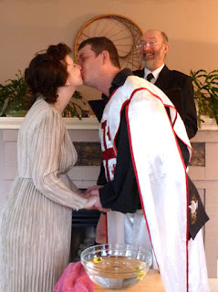 Kent Buttars, Seattle Wedding Officiant, smiles as Morgan and Chris share their wedding kiss Chris and Morgan kiss to seal their wedding vows - Kent Buttars, Seattle Wedding Officiant