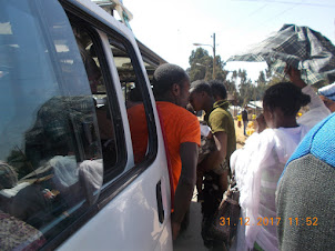 The queue and rush to board the shared "Mini Van Taxi" to Mt Entoto.