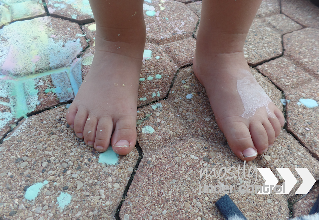 child's feet covered in chalk paint