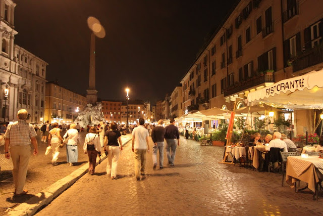 A lot of cafes and restaurants are situated along the sidewalk of Piazza Navona in Rome, Italy A lot of cafes and restaurants are situated along the sidewalk of Piazza Navona in Rome, Italy
