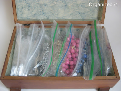 necklaces in plastic bags in a wooden box