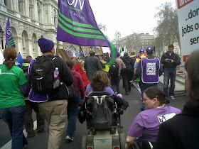 The backs of people marching along Whitehall, including Lou and me