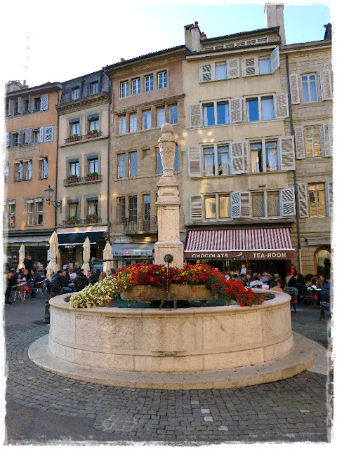 Fountain on the Place de Bourg de Four, Geneva, Switzerland, decked out in autumn Chrysanthemums.