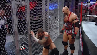 CM Punk tries to open the cage to escape from Ryback