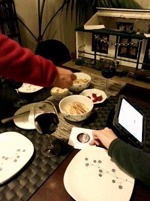 Dining table with snacks laid out. At the back of the table is a dolls' house miniature school.