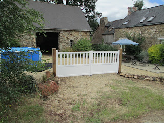 New gates on oak posts with view of the large patio and pool behind