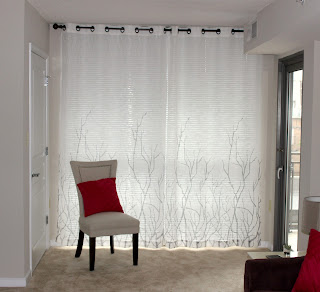 a chair in front of curtains in a house