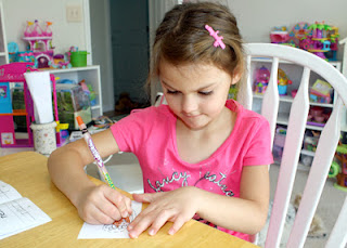 After writing the selected words, Tessa colored the corresponding pictures.