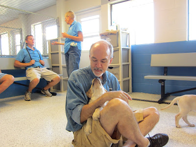 Fred has some puppy love as a yellow lab puppy kisses him