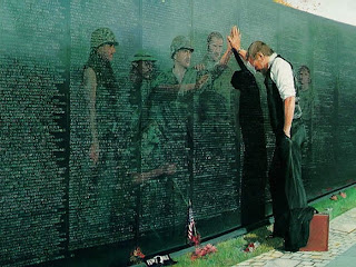 business man reflecting in sorrow of soldiers he fought with in battle who lost their lives - their images are seen in the reflection of the wall