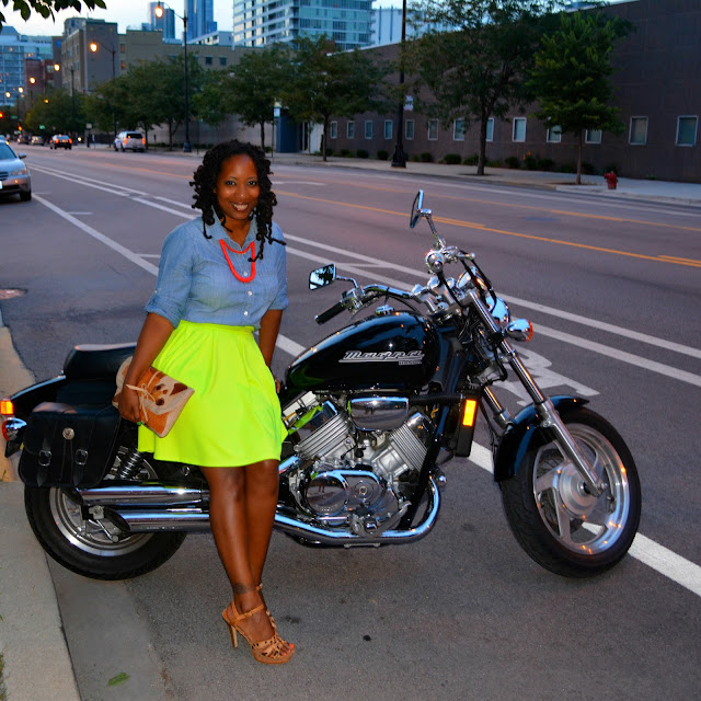 wearing neon skirt sitting on motorcycle