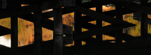 sunset through bridge timbers