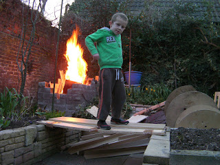 burning planks of wood and cable drums on home bonfire
