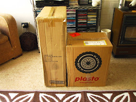 Two large shipping cartons sitting on a living room floor.