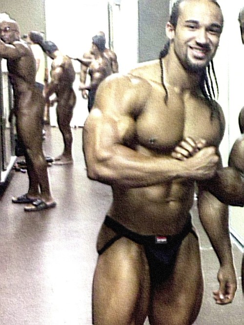 Upfront: BodyBuilder in Jockstrap Background: Naked BodyBuilders... likely ...