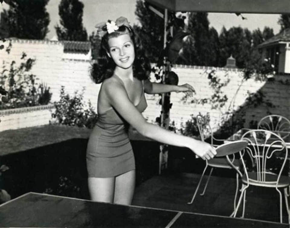 A young Rita Hayworth at home playing Ping Pong