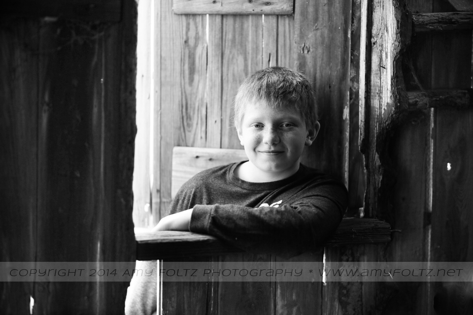 photo of a young boy inside an old barn