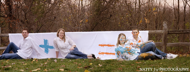 Soon to be married couple poses in front of math equation for their paint fight engagement session
