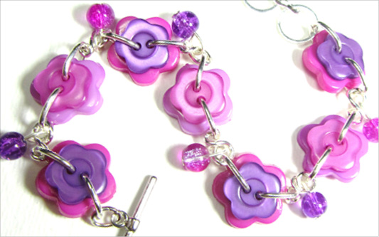 Arm Candy Flower Bracelet Bright bracelet is made with colorful flower buttons and cute crackle beads